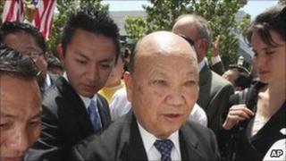 May 11, 2009 file photo, former Laotian General Vang Pao, centre, is escorted by supporters to the federal courthouse, in Sacramento, California