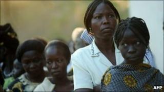 Southern Sudanese women queue outside the University of Juba polling centre on 10 January 2010