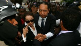Former Haitian president Jean-Claude "Baby Doc" Duvalier and his wife Veronique Roy depart court on 18 January 2011