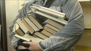 Man with lots of books in his hand