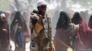 An Islamist al-Shabab soldier carries his gun on a street in southern Mogadishu