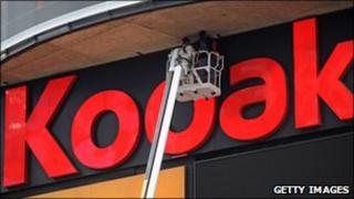 Workers fix Kodak sign