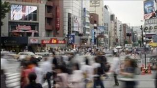 Pedestrians crossing busy street in Tokyo