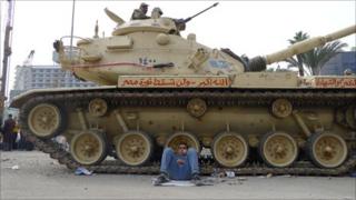 Protester and tank in Tahrir Square