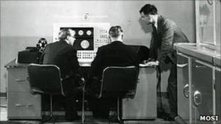 Christopher Strachey (l) and Alan Turing (r) working on the Ferranti Mark I