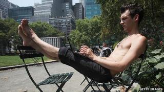Man using laptop in Bryant Park, NYC