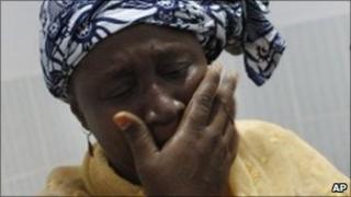 Woman cries after seeing her shot relative in Abidjan