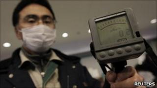An employee of Yamagata city office holds a Geiger counter to detect radiation