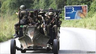 Soldiers loyal to Ivory Coast presidential claimant Alassane Ouattara ride in a vehicle in the main city Abidjan, 6 April 2011