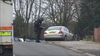 Army technical officers dealing with one of the suspect devices