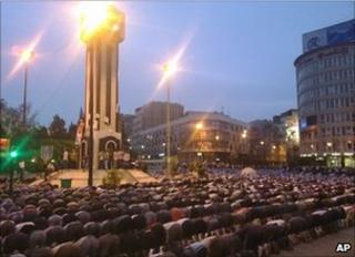 Syrians pray in Clock Square in Homs, 18 April (citizen journalism image)