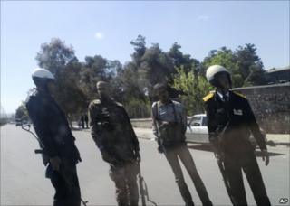 Members of the Syrian security forces man a checkpoint in Damascus, 24 April (image taken on mobile phone through windowscreen)