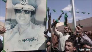 Libyan soldiers hold a poster of Col Muammar Gaddafi - 27 April 2011