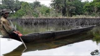 A man paddling a canoe in Rivers state, Nigeria
