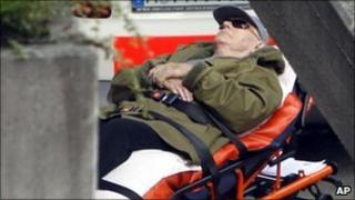 John Demjanjuk arrives on a stretcher at the court building in Munich, Germany, 11 May 2011