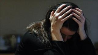 Woman with head in hands