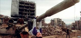 A boy playing on a tank in the Sarajevo neighbourhood of Grbavica, April 1996