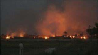 Smoke rises after a clash between farmers and police at Bhatta Parsaul villages
