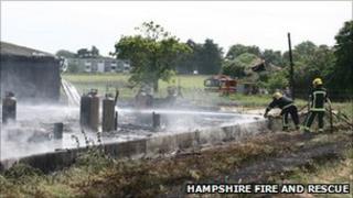 Firefighters dampening down cylinders