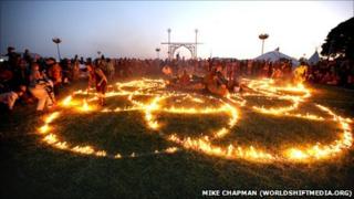 Festival-goers play with fire at the Sunrise Celebration
