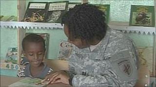 Capt Courtney Sanders teaching a child to read