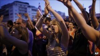 People outside the parliament building in Athens protest against any further budget cuts (19 June 2011)