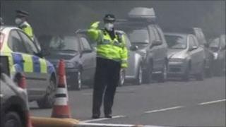Police woman in mask directing traffic