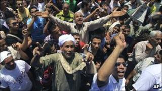 Egyptians chant slogans as they attend the weekly Friday protest in Tahrir Square in Cairo, Egypt, on 17 June