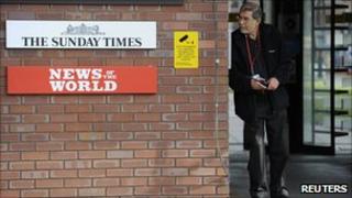 A security guard stands at the entrance to News International offices in Wapping