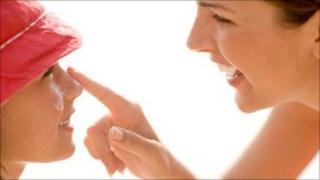 woman applying suncream to child