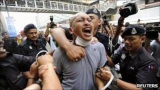 Police detain a supporter of the Bersih electoral reform coalition during a rally in Kuala Lumpur July 9, 2011