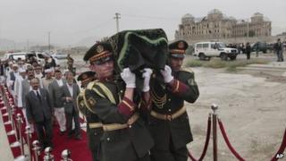Afghan army soldiers carry coffin of Mohammed Ashim Watanwal who was killed by armed gunmen during Sunday"s attack, during his funeral procession in Kabul, Afghanistan, Monday, July 18, 2011