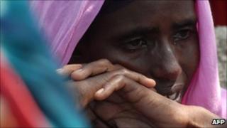 A displaced Somali woman cries after one of her children died of malnutrition at a camp near Mogadishu airport