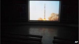 A video shows the launch in 2009 of a North Korean Unha-2 rocket on a screen inside a hall in Pyongyang, 18 April 2011