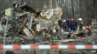 This photo taken on April 11, 2010 shows Russian rescuers inspecting the wreckage of a Polish government Tupolev Tu-154 aircraft near Smolensk airport