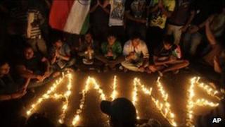 Supporters of Indian anti-corruption activist Anna Hazare gather around lighted candles outside the Tihar prison in Delhi, 17 August 2011