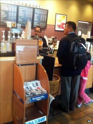 Gary Locke, pictured in Seattle, ordering coffee with his daughter on 12 August 2011