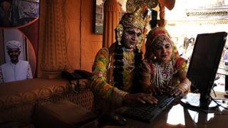 Performers working at a computer