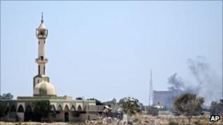 Smoke rises over buildings in the main compound of Muammar Gaddafi in the Bab Al-Aziziya district of Tripoli