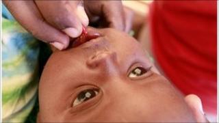 Child being given vitamin A tablet