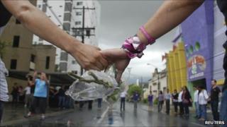 Casino Royal employees pray for victims of the attack in Monterrey on 26 August 2011
