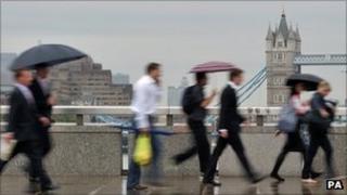 City workers walk over London Bridge in central London