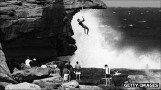 Bare-handed rope climbing on Bondi beach, Australia