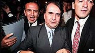 Alberto Santofimio (centre) is taken into custody in 1995