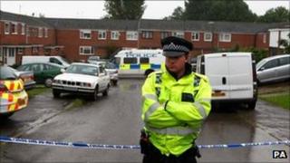A police officer outside the house in Thame