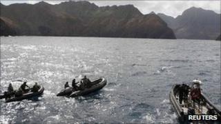 Rescue workers search remains of the plane that crashed near Juan Fernandez islands, about 420 miles (670 km) off Chile's coast, 4 September 2011