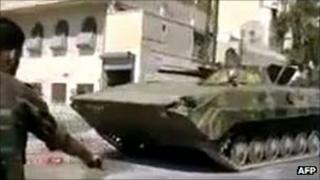 Syrian soldier said to be firing at the body of a protester (out of picture) in Homs, 5 September