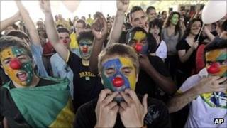 Protesters wearing clown noses whistle and shout during the march against corruption in Brasilia, Brazil, 7 September 2011