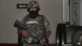 A member of the Mexican navy with telecoms gear of the Zetas drug cartel in Veracruz, Mexico, Thursday 8 Sept