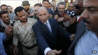 Libyan Transitional National Council chairman Mustafa Abdel Jalil, centre right, flanked with Libya former rebels" Tripoli military commander Abdel Hakim Belhaj, left, after arriving at Metiga airport in Tripoli Sept. 10, 2011.